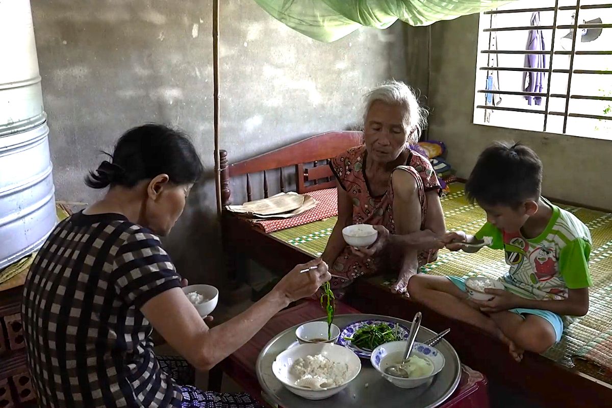 Bà cố, bà ngoại và em Huy với bữa cơm chỉ có rau luộc và cơm nguội.